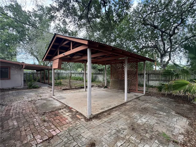 a backyard of a house with table and chairs