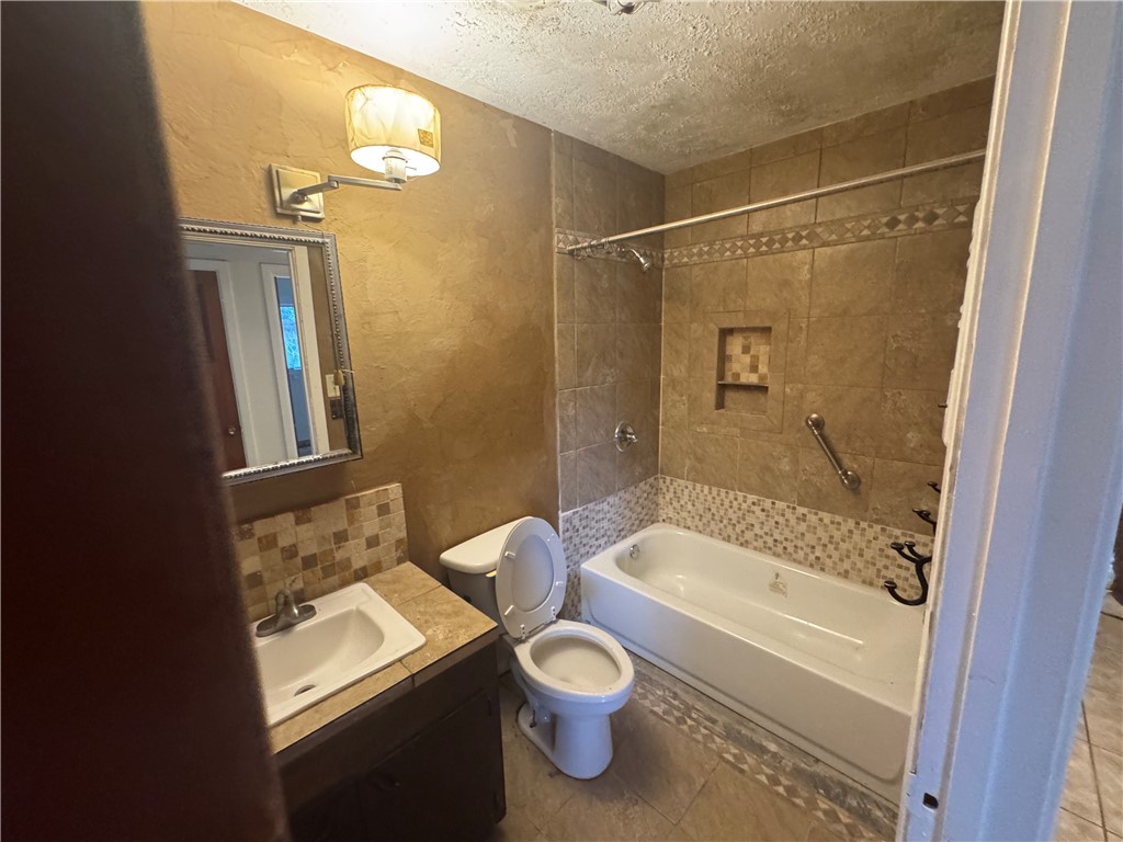 409 Taylor Road Falfurrias, TX 78355 - Photo 9 of 13 a bathroom with a sink toilet and shower