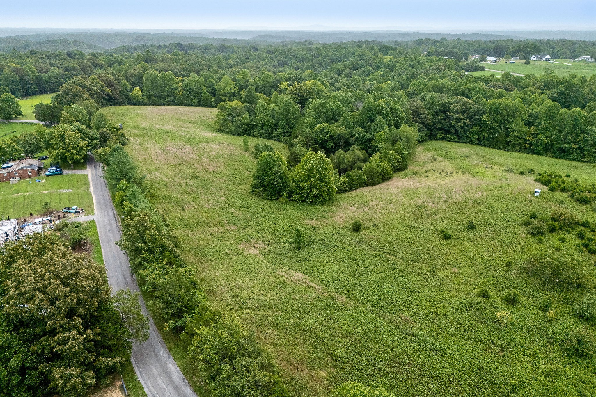 0 Four 4 Seasons Road Smithville, TN 37166 - Photo 3 of 17 a view of a lush green forest with trees and houses