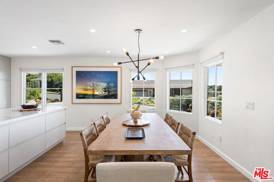 20413 Roca Chica Drive Malibu, CA 90265 - Photo 11 of 27 a view of a dining room with furniture window and wooden floor