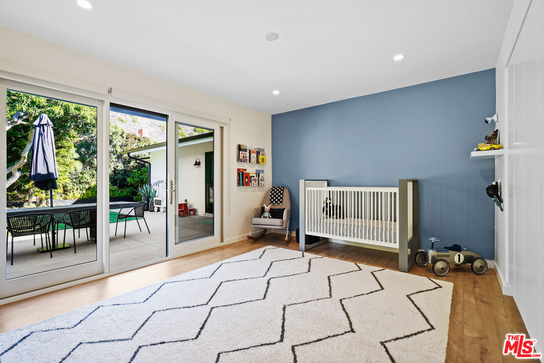 20413 Roca Chica Drive Malibu, CA 90265 - Photo 19 of 27 a bedroom with a bed and a large window