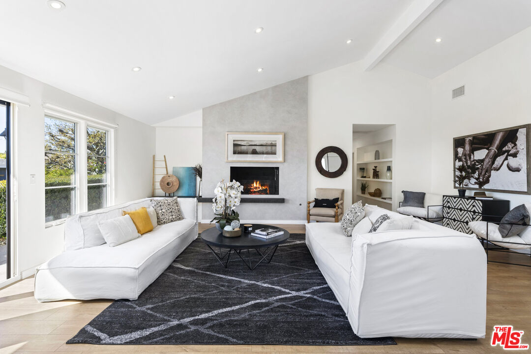 20413 Roca Chica Drive Malibu, CA 90265 - Photo 7 of 27 a living room with fireplace furniture and a large window