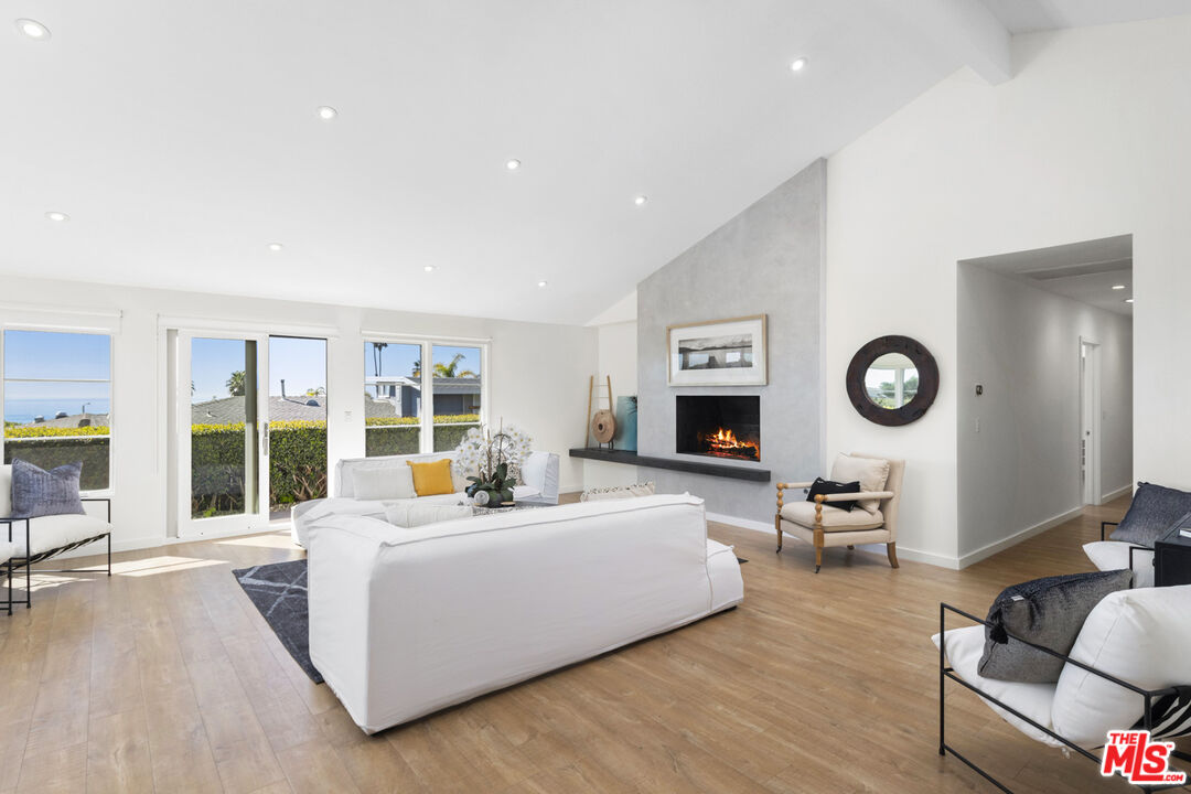 20413 Roca Chica Drive Malibu, CA 90265 - Photo 8 of 27 a living room with furniture and a wall painting