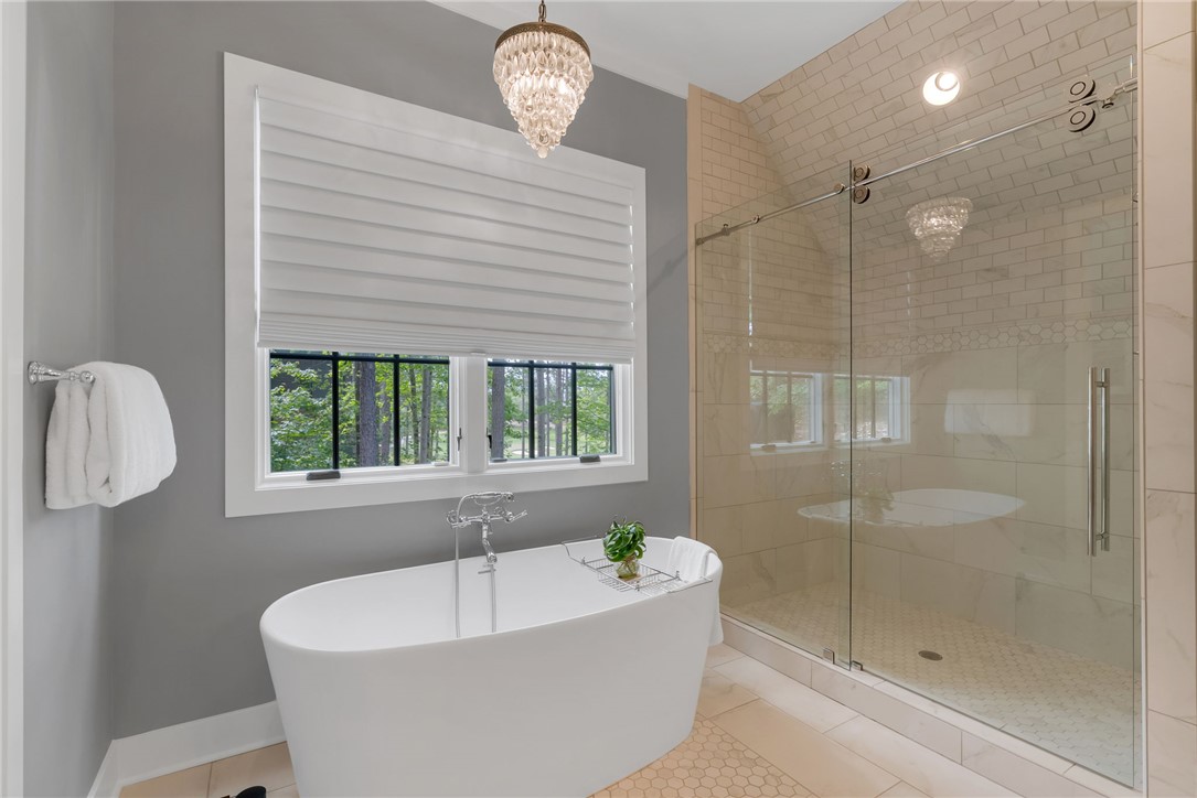 119 Drewberry Lane Sunset, SC 29685 - Photo 15 of 42 This spacious bathroom offers a relaxing soaking tub and a sleek, modern glass-enclosed shower.