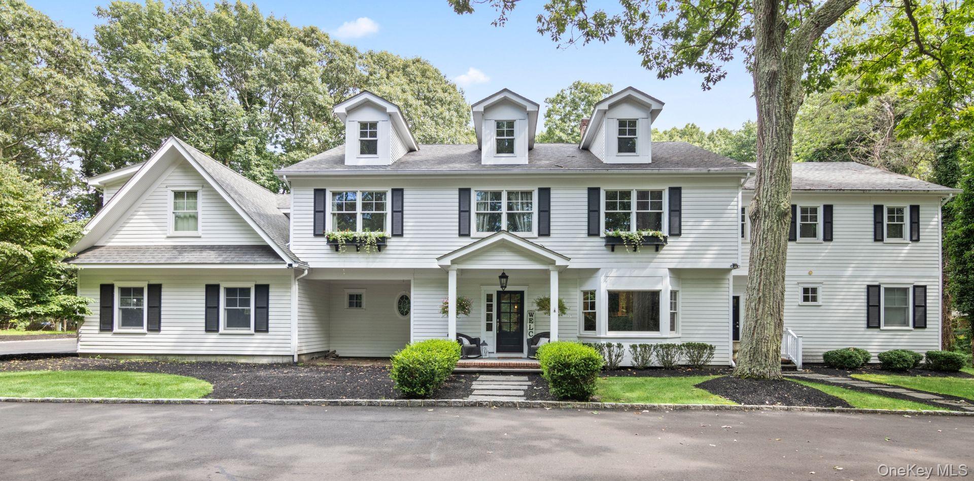 front view of a brick house with a yard