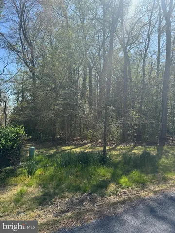 a backyard of a house with a yard and outdoor seating