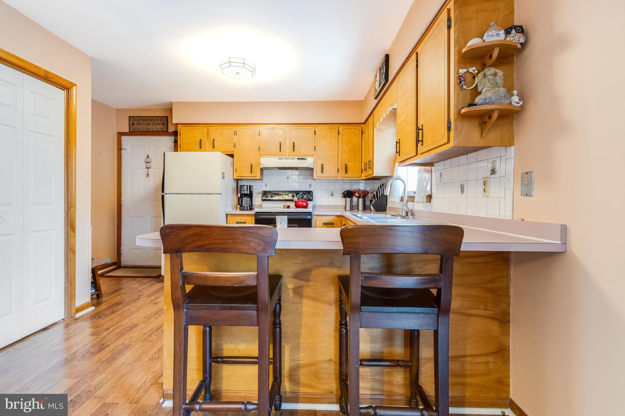 116 Red Cedar Drive Milton, DE 19968 - Photo 11 of 44 a kitchen with stainless steel appliances a stove a refrigerator and a dining table with painted walls