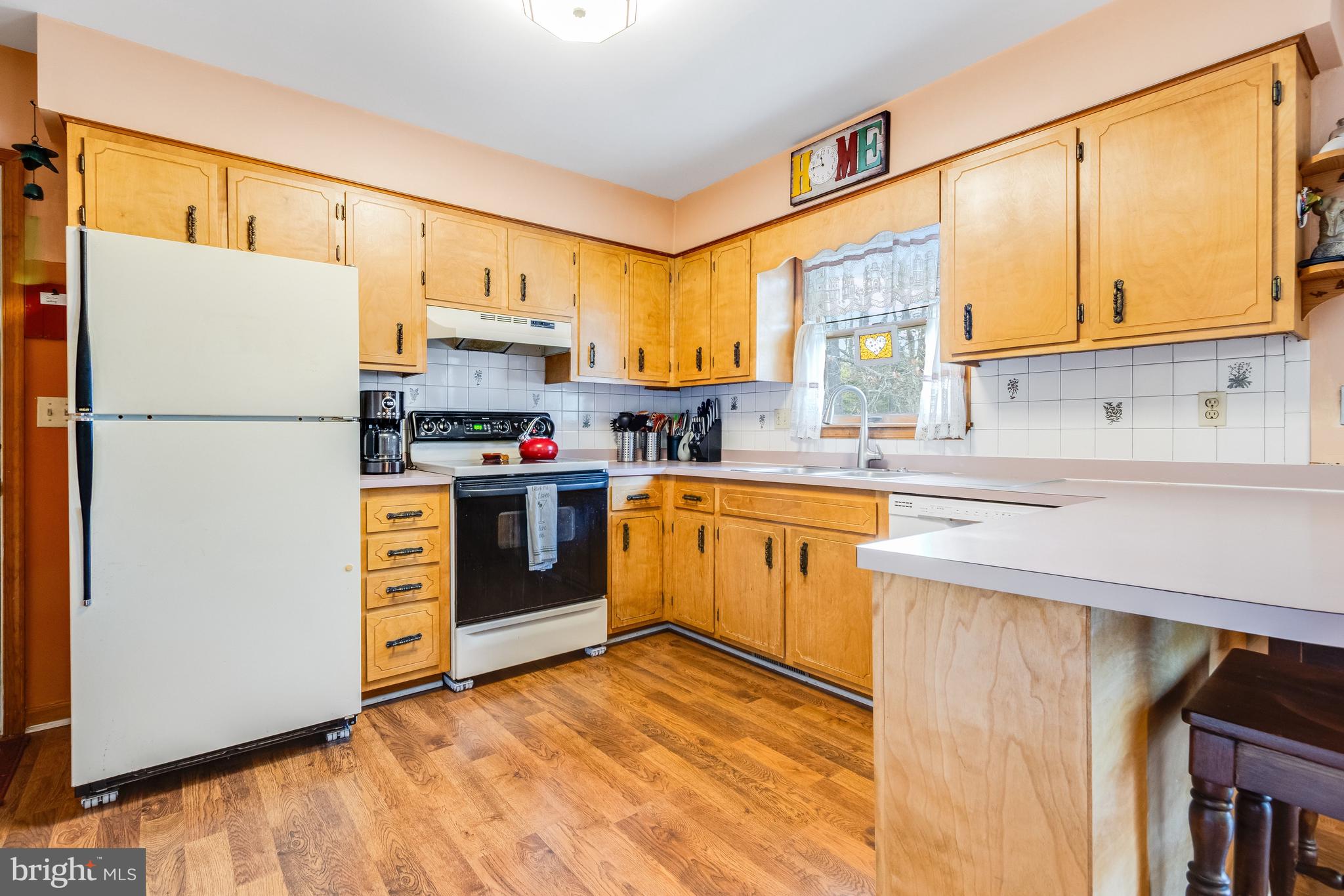 116 Red Cedar Drive Milton, DE 19968 - Photo 12 of 44 a kitchen with stainless steel appliances a refrigerator sink and cabinets