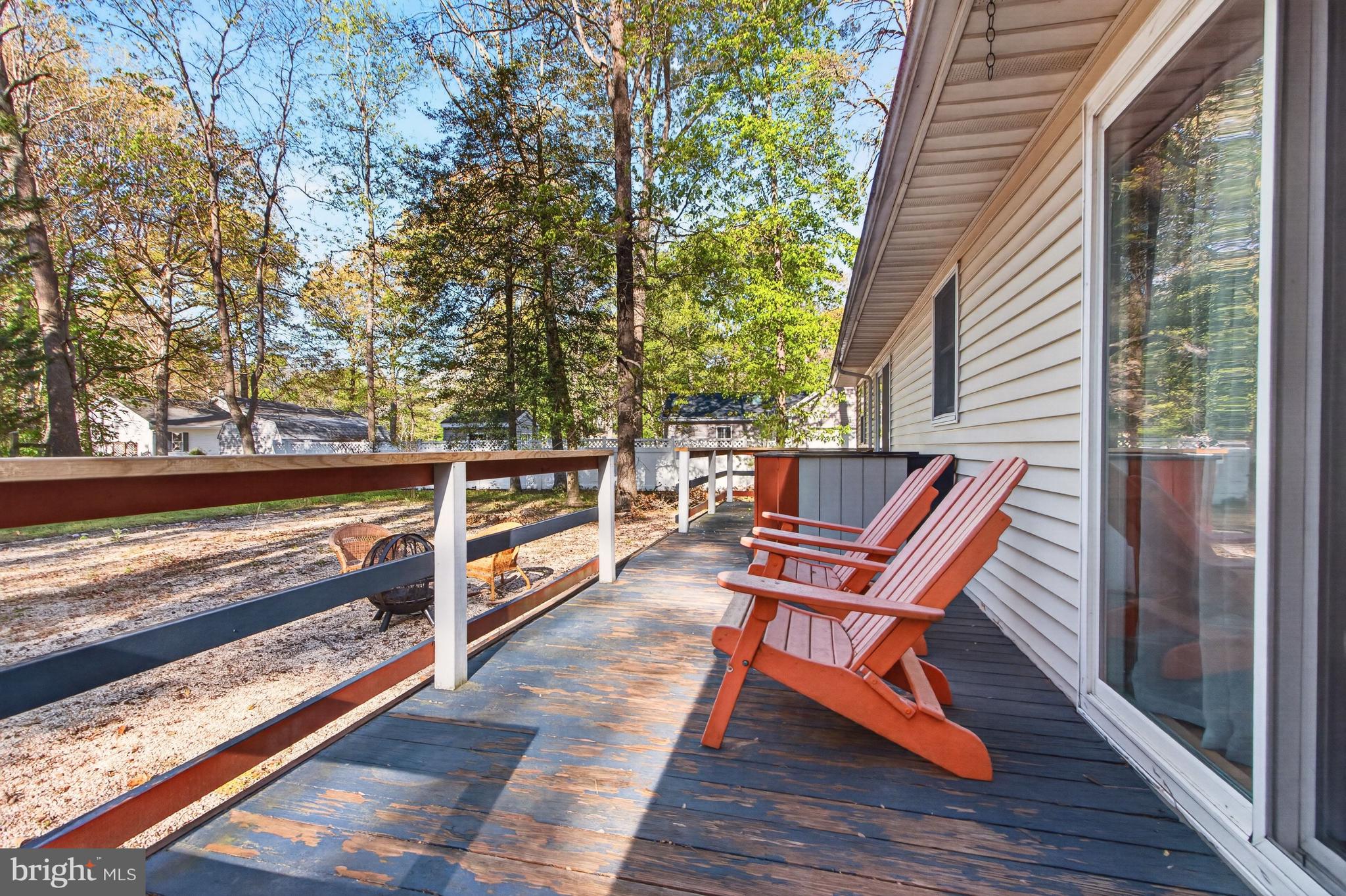 116 Red Cedar Drive Milton, DE 19968 - Photo 33 of 44 a backyard of a house with wooden floor and outdoor seating
