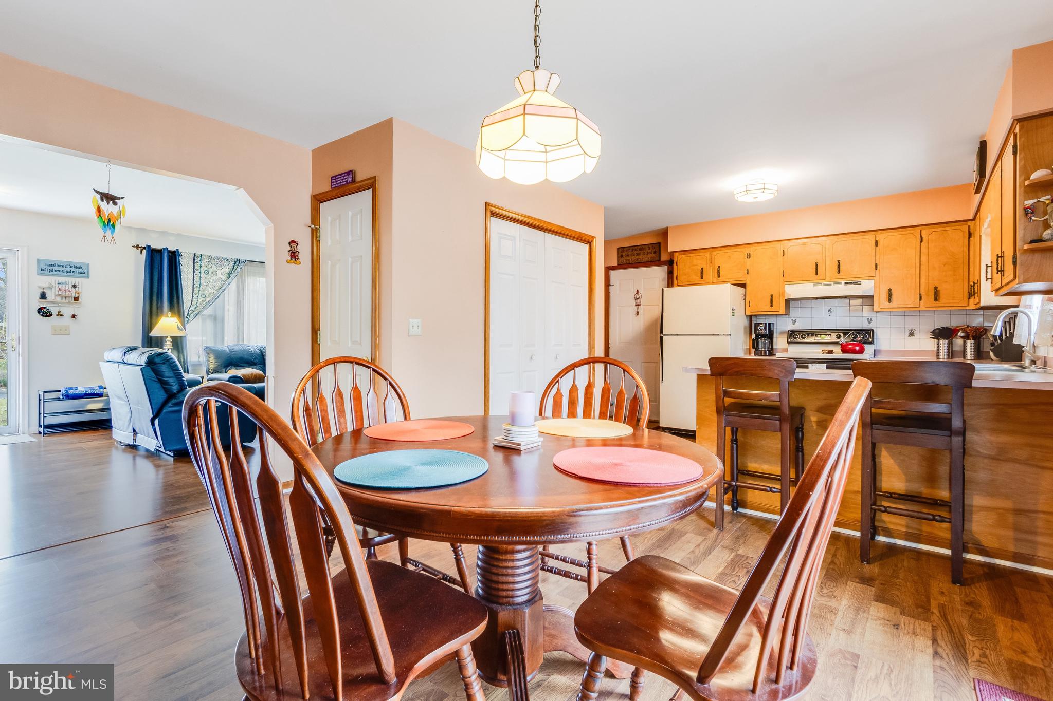 116 Red Cedar Drive Milton, DE 19968 - Photo 10 of 44 a dining room with furniture a chandelier and wooden floor