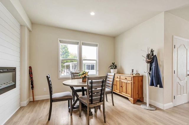 a view of a dining room with furniture and a window