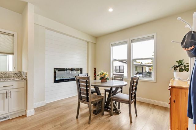 a view of a dining room with furniture and a window