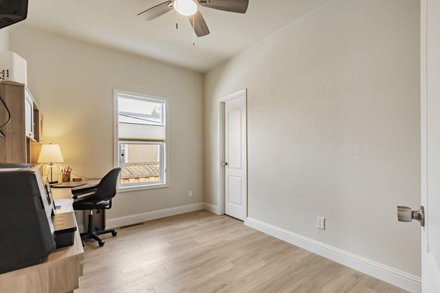 a view of a workspace with furniture and a window