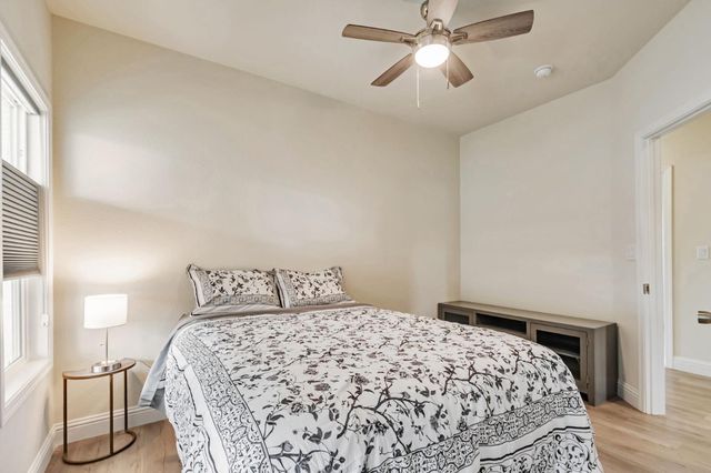 a bedroom with a bed and a chandelier