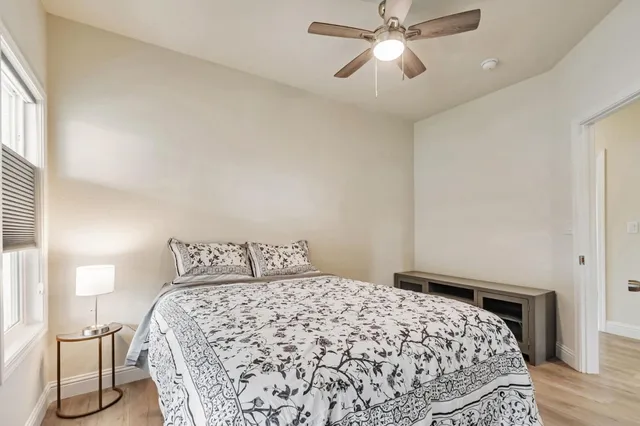 a bedroom with a bed and a chandelier