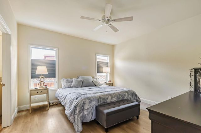 a bedroom with a large bed and a window