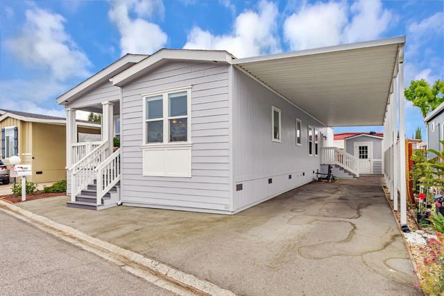 a view of a house with a yard and garage