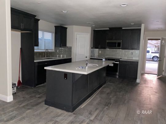 1308 Sims Street Ridgecrest, CA 93555 - Photo 2 of 12 a kitchen with stainless steel appliances granite countertop a stove a sink and a refrigerator