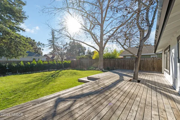 a view of a yard with wooden deck