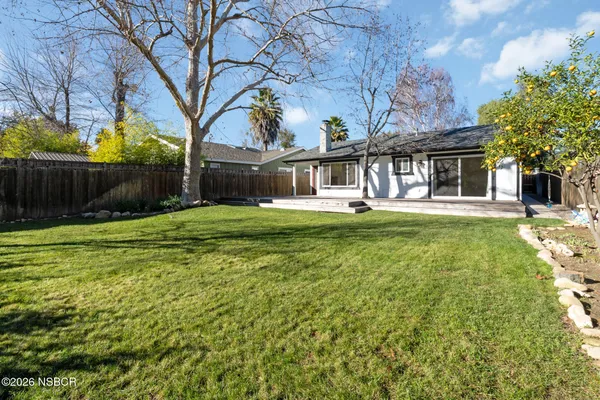 a front view of house with yard and green space