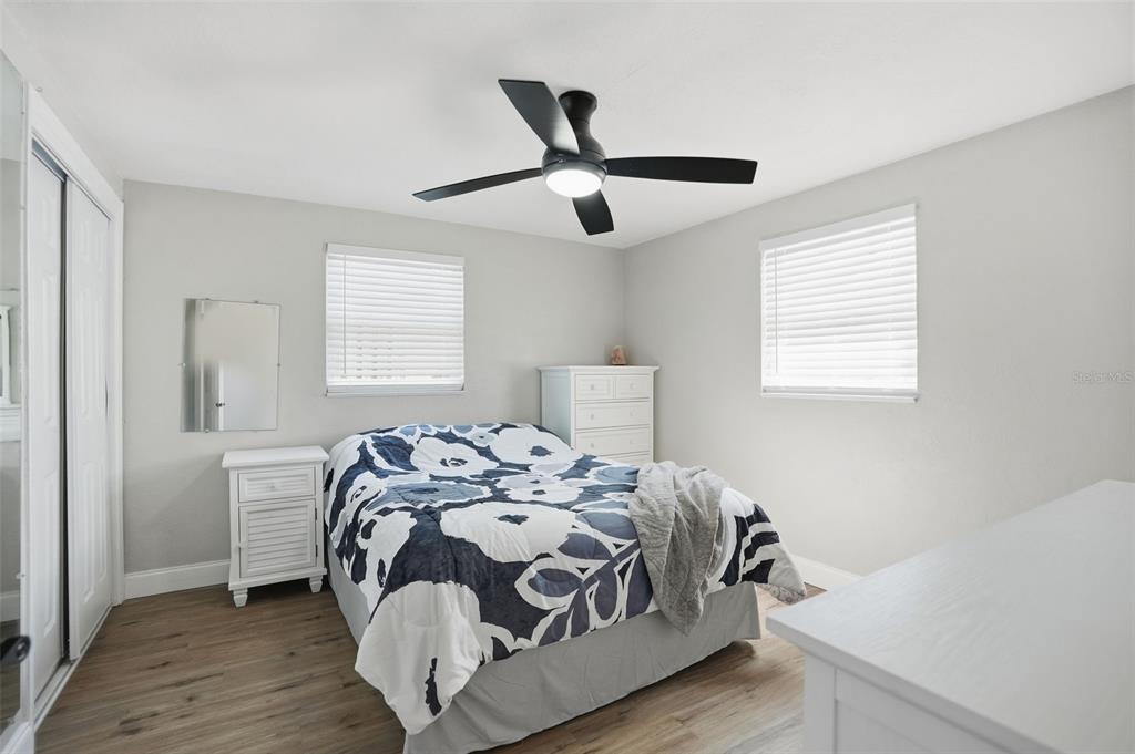 4750 Foothill Drive Holiday, FL 34690 - Photo 19 of 38 a bedroom with a bed and wooden floor