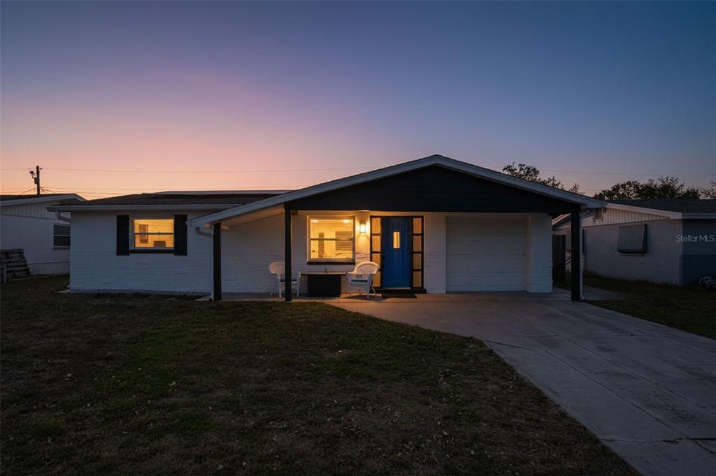 4750 Foothill Drive Holiday, FL 34690 - Photo 2 of 38 a front view of a house with a yard