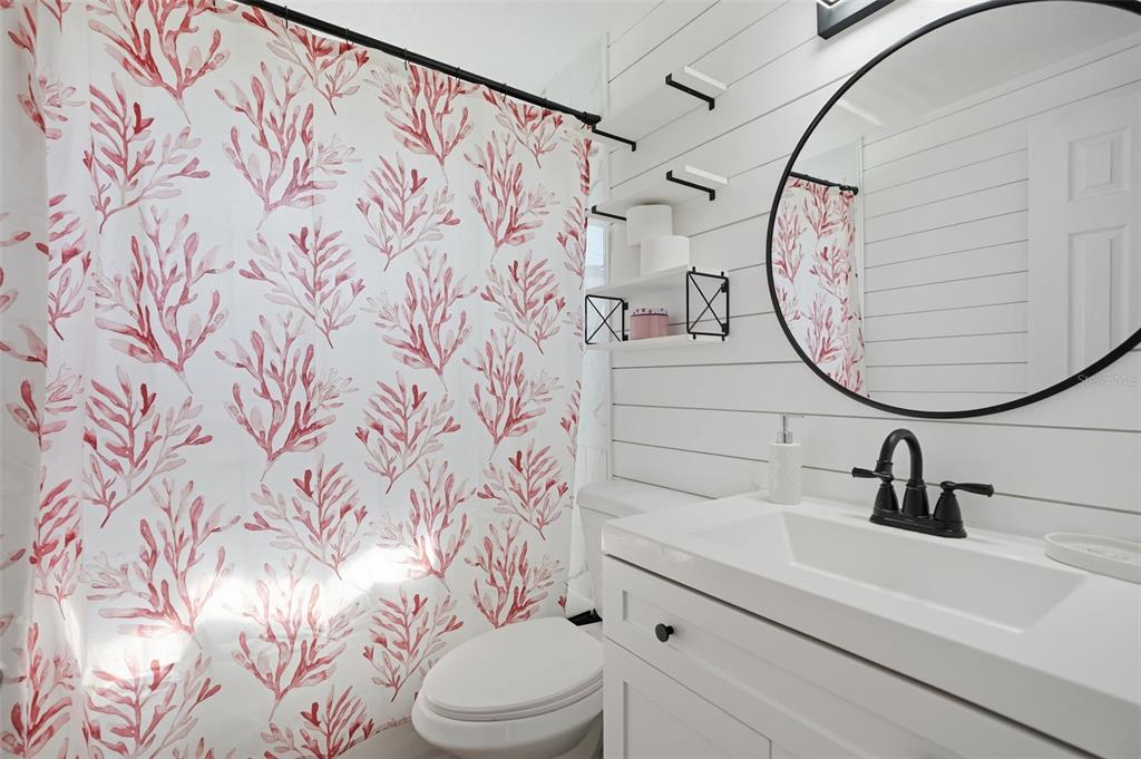 4750 Foothill Drive Holiday, FL 34690 - Photo 22 of 38 a bathroom with a sink and mirror with toilet