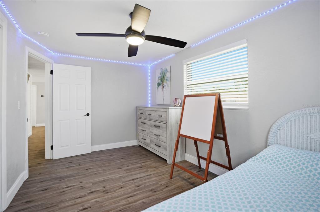 4750 Foothill Drive Holiday, FL 34690 - Photo 25 of 38 a view of a bedroom with furniture and wooden floor