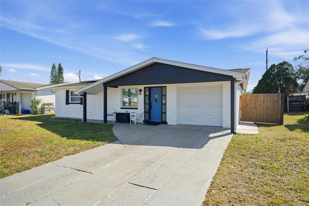 4750 Foothill Drive Holiday, FL 34690 - Photo 4 of 38 a front view of a house with a yard and garage