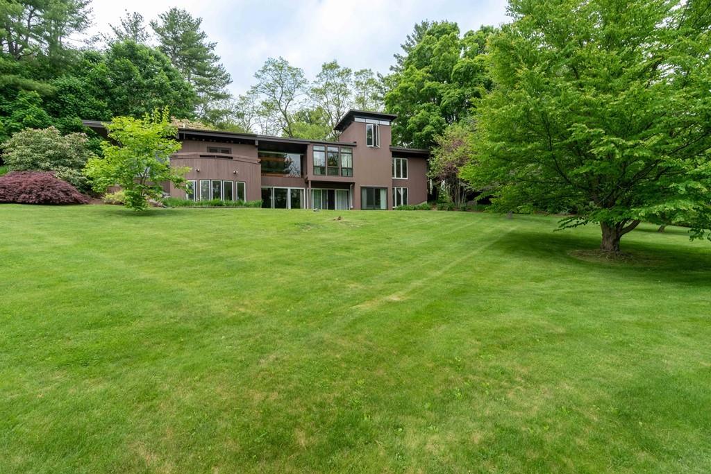 67 Conant Road Lincoln, MA 01773 - Photo 2 of 38 a view of a house with a big yard plants and large trees
