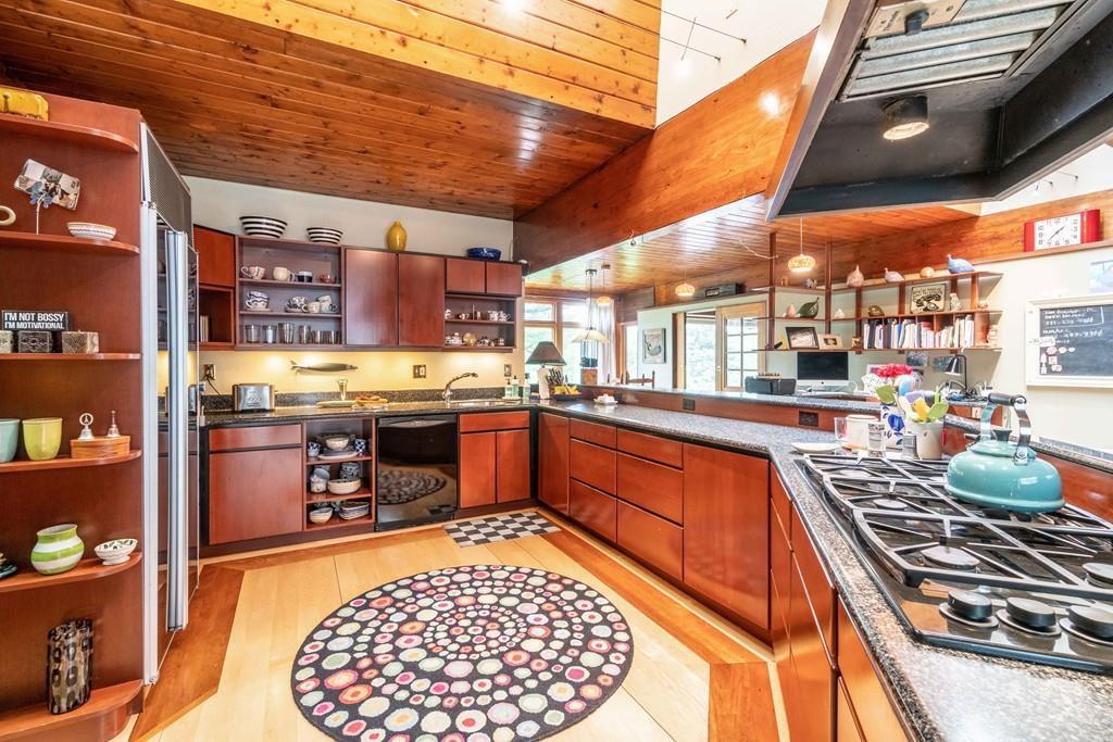 67 Conant Road Lincoln, MA 01773 - Photo 21 of 38 a kitchen with stainless steel appliances granite countertop a stove a sink and a microwave