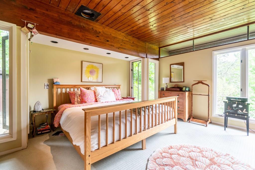 67 Conant Road Lincoln, MA 01773 - Photo 24 of 38 a bedroom with bed and a chandelier