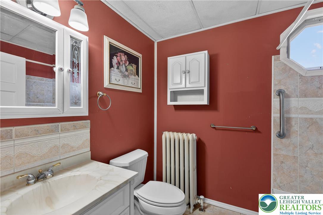 108 West 2nd Street Alburtis, PA 18011 - Photo 16 of 24 a white toilet sitting next to a bathroom sink