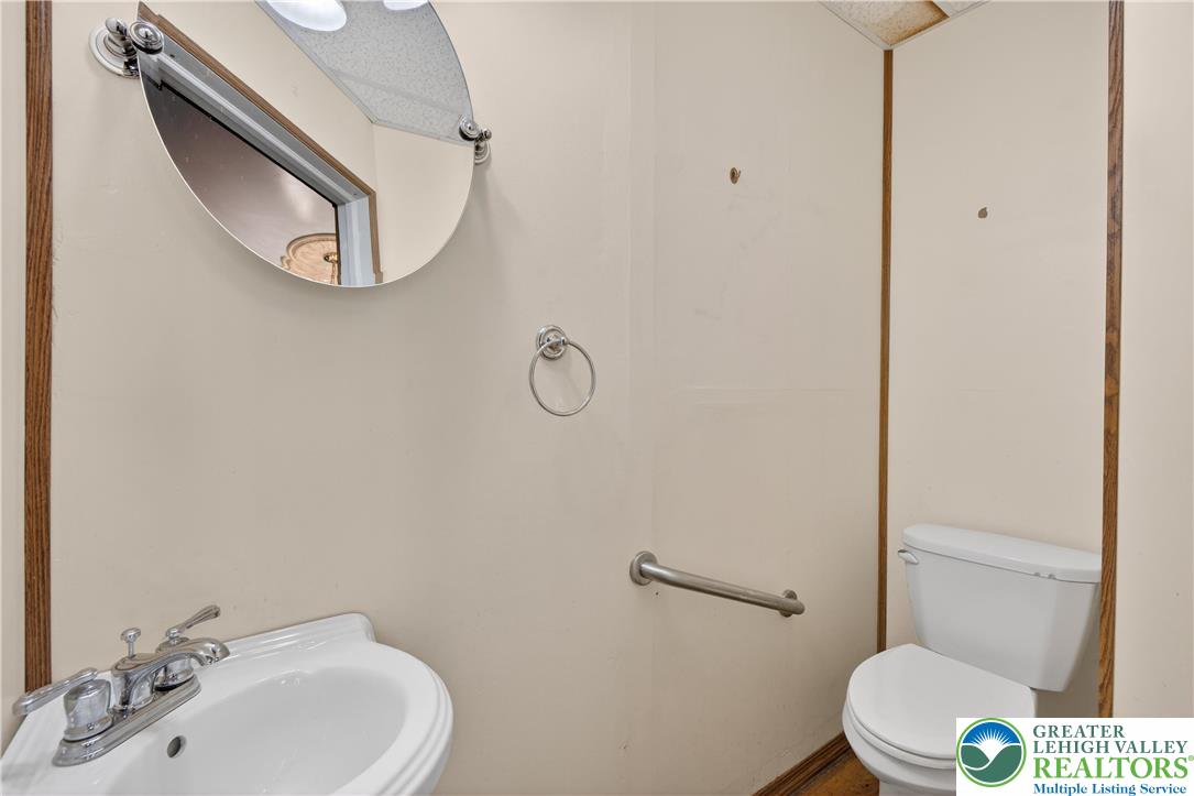 108 West 2nd Street Alburtis, PA 18011 - Photo 18 of 24 a bathroom with a toilet a sink and mirror