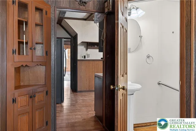 a view of a hallway with wooden floor and staircase