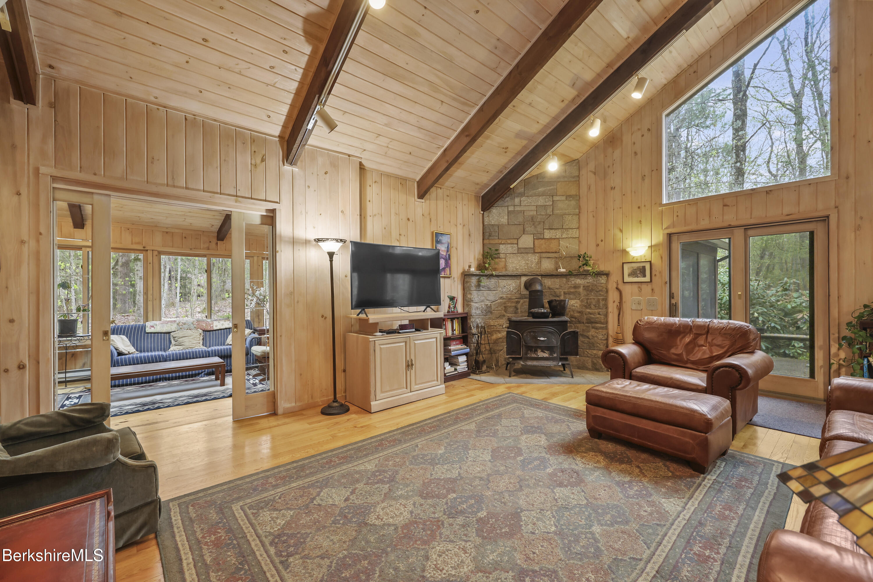 422 Bonny Rigg Hill Road Becket, MA 01223 - Photo 3 of 60 a living room with furniture a flat screen tv and a floor to ceiling window