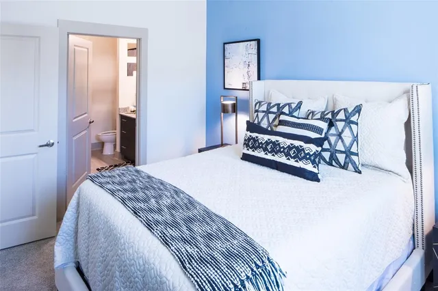 a bedroom with a bed and a table