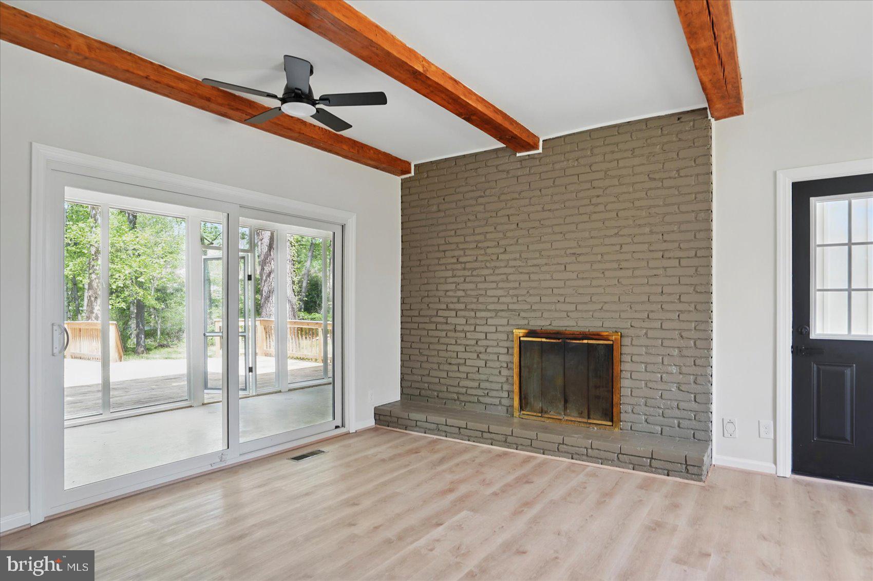 1504 Ameshire Road Lutherville-Timonium, MD 21093 - Photo 16 of 54 a view of empty room with wooden floor and fireplace