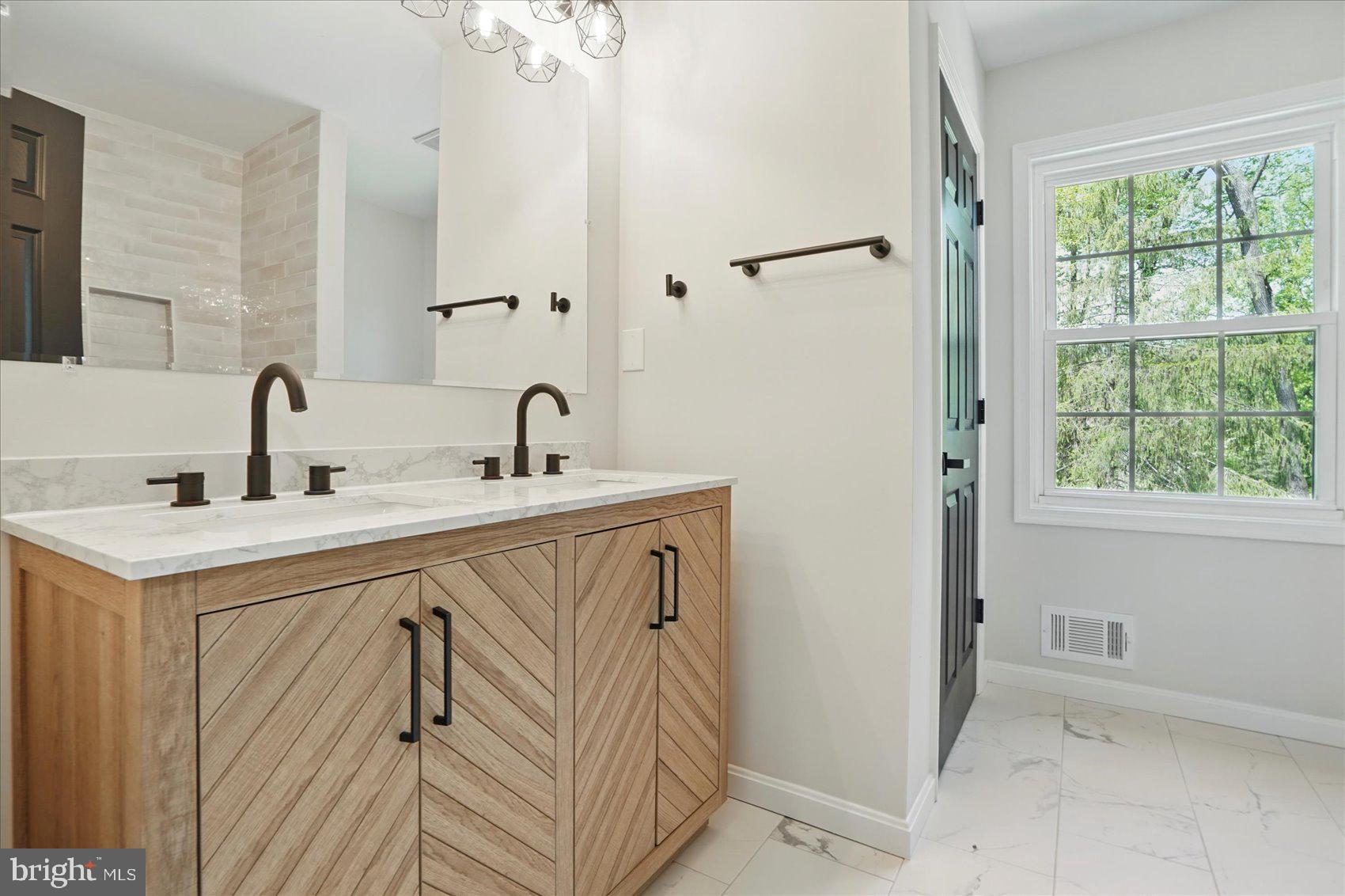 1504 Ameshire Road Lutherville-Timonium, MD 21093 - Photo 30 of 54 a bathroom with a sink a mirror and shower