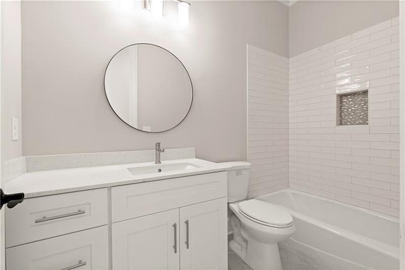 222 Trecastle Square, Unit 21 Canton, GA 30114 - Photo 12 of 45 a bathroom with a sink a toilet and a mirror