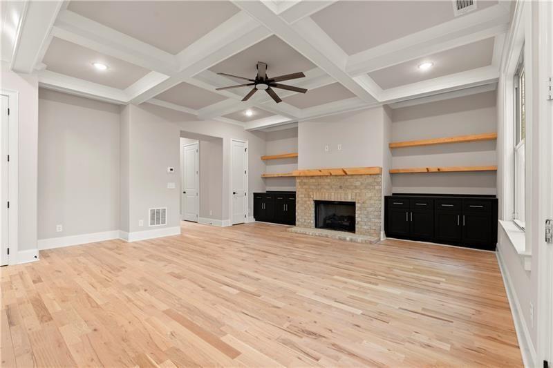 222 Trecastle Square, Unit 21 Canton, GA 30114 - Photo 4 of 45 a view of an empty room with a fireplace and a ceiling fan