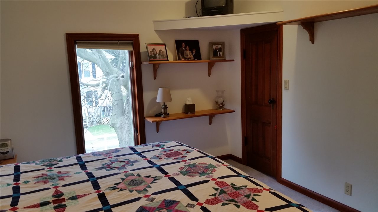 3112 East Holcomb Road Oregon, IL 61061 - Photo 17 of 25 a bedroom with a bed and wooden floor
