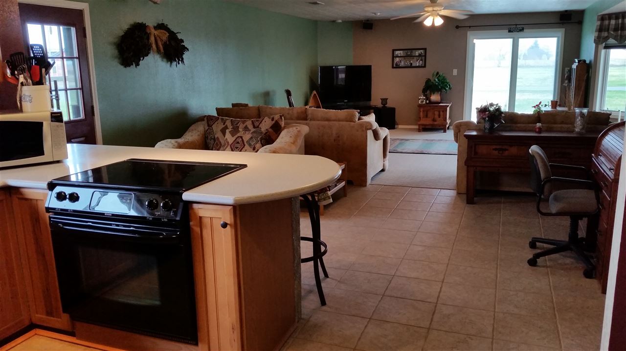 3112 East Holcomb Road Oregon, IL 61061 - Photo 8 of 25 a living room with furniture a flat screen tv and a fireplace