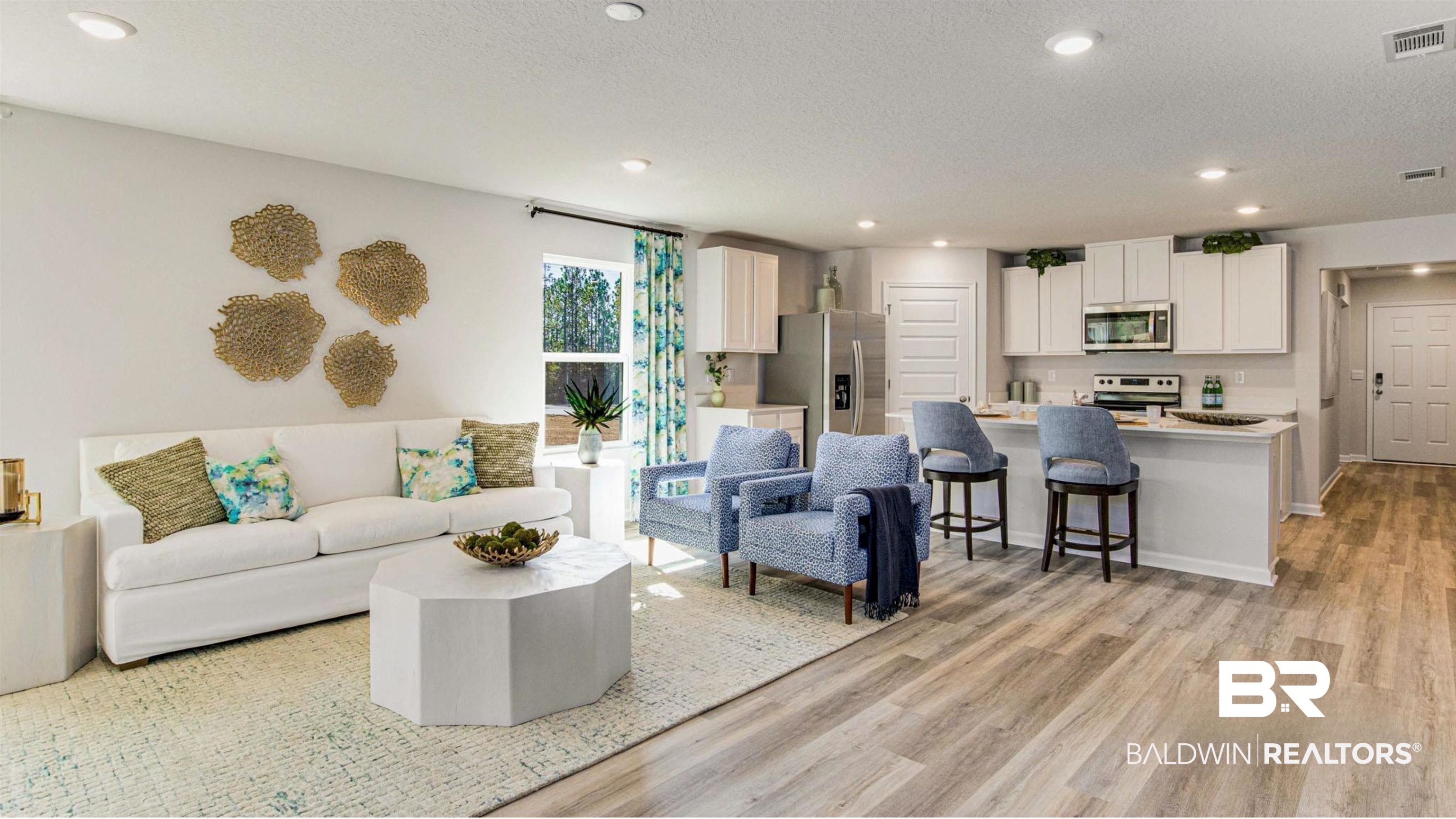 1040 Hayward Loop Foley, AL 36535 - Photo 6 of 35 Open-concept living area featuring wood-finish flooring, recessed lighting, a kitchen island with seating, a window with outdoor scenery, and white wall finishes