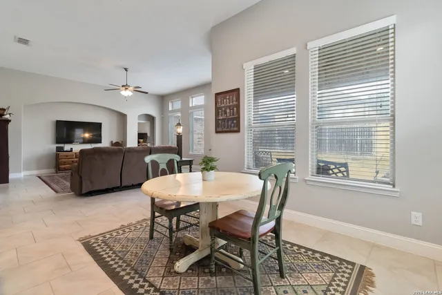 a view of a a dining room with furniture window and wooden floor