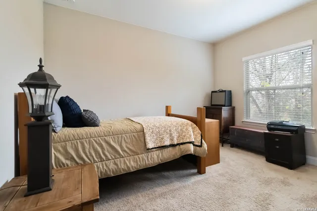 a bedroom with a bed and window
