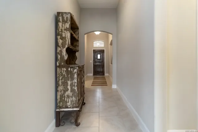 a view of a entryway door with a hallway