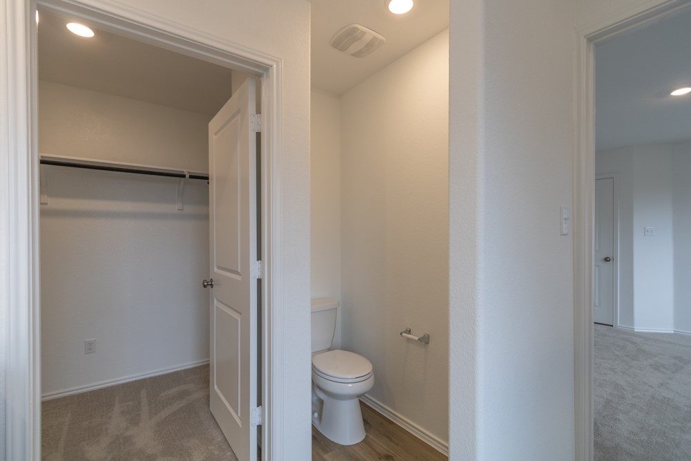 309 Canley Loop Hutto, TX 78634 - Photo 21 of 27 a bathroom with a granite countertop toilet