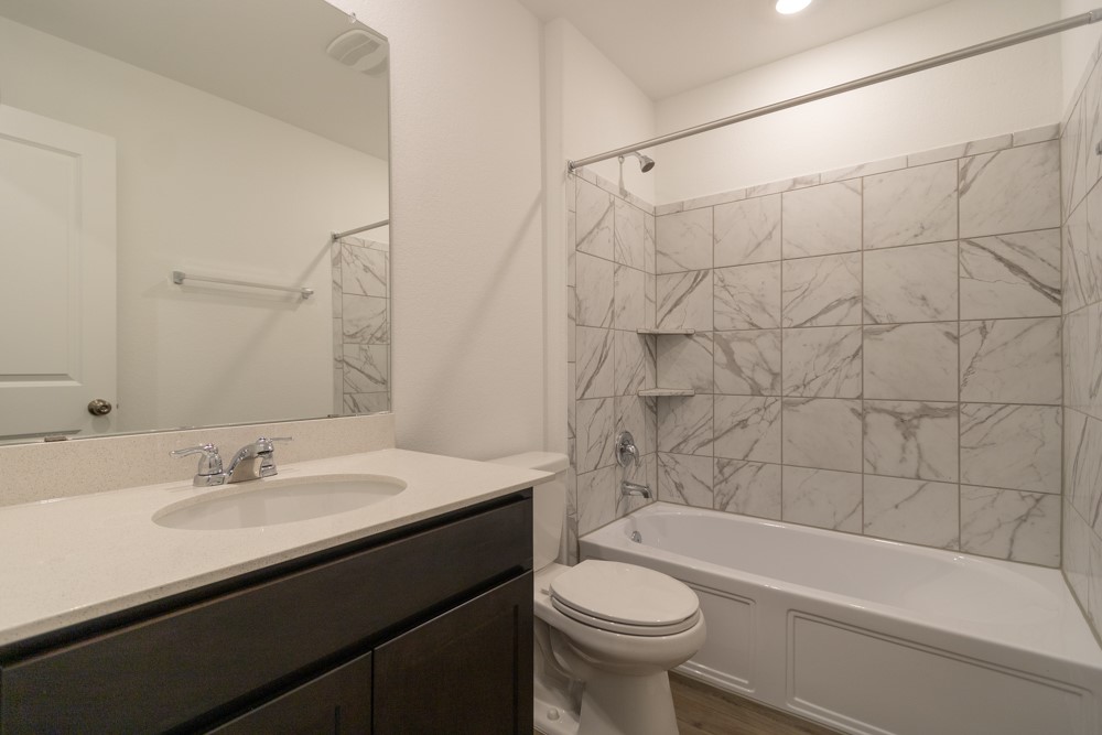 309 Canley Loop Hutto, TX 78634 - Photo 22 of 27 a bathroom with a sink a toilet and bathtub