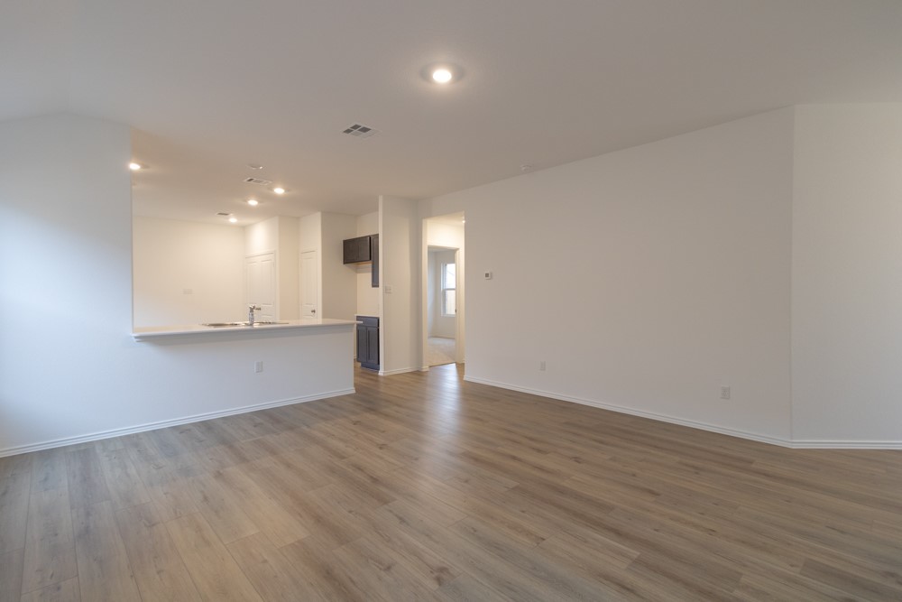 309 Canley Loop Hutto, TX 78634 - Photo 8 of 27 a view of an empty room and wooden floor